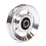 The Bells of Steel Aluminum Pulley Wheels & Upgrade Kits feature a shiny, circular pulley with three large holes and a central bearing—ideal for upgrading your cable machine. Photographed on a white background.