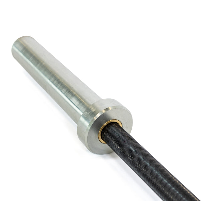 A close-up of the Bells of Steel Rackable EZ Curl Bar showcases its metallic, cylindrical sleeve attached to a dark, textured shaft. This design emphasizes its functionality for arm development during weightlifting or bicep curls.