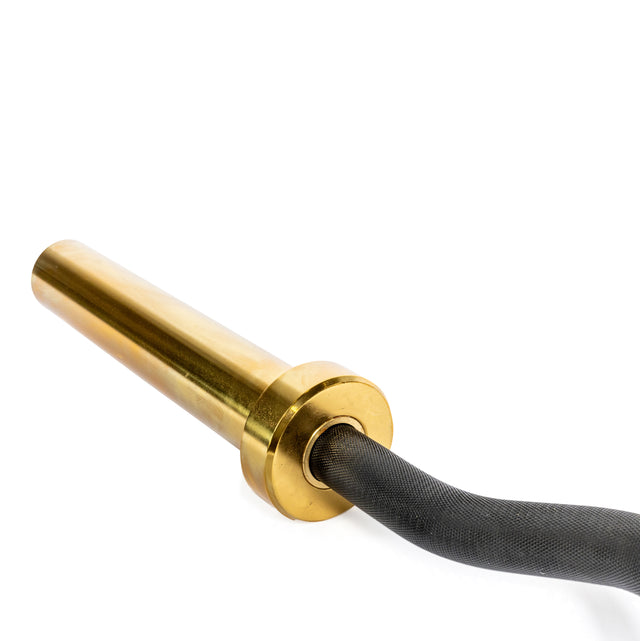 A golden wheel hub with a polished finish resembles the smooth curves of a Bells of Steel EZ Curl Bar (54.5"), seamlessly connected to a black rubber tire, all set against a pristine white background.