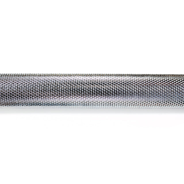 A close-up of a textured grip on the Bells of Steel Lat Pulldown Bar against a white background highlights intricate diamond patterns that enhance grip during workouts, with a shiny, reflective surface reminiscent of the bar's precision-engineered rotating connection point.