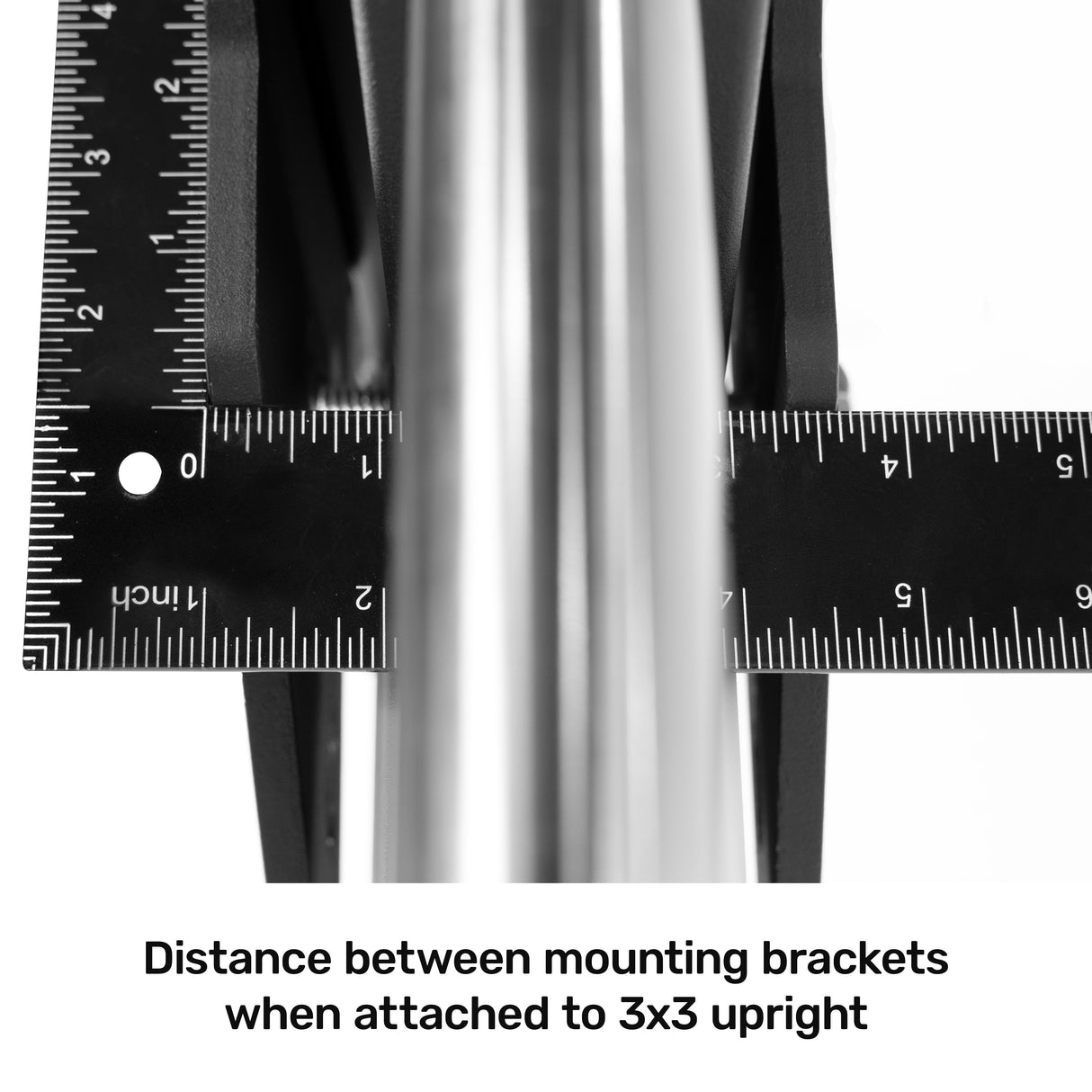 Close-up of two black rulers measuring the distance between mounting brackets on a "3x3" metal upright, with text below reading, "Bells of Steel Smith Machine Rack Attachment: Distance between mounting brackets when attached to a 3x3 upright, ideal for power rack setups.