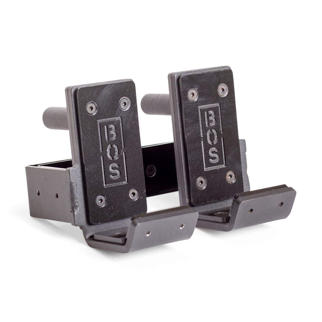 A pair of Standard J-Cups by Bells of Steel, made of metal with padded UHMW surfaces, designed to securely hold barbells on a power rack or squat rack.