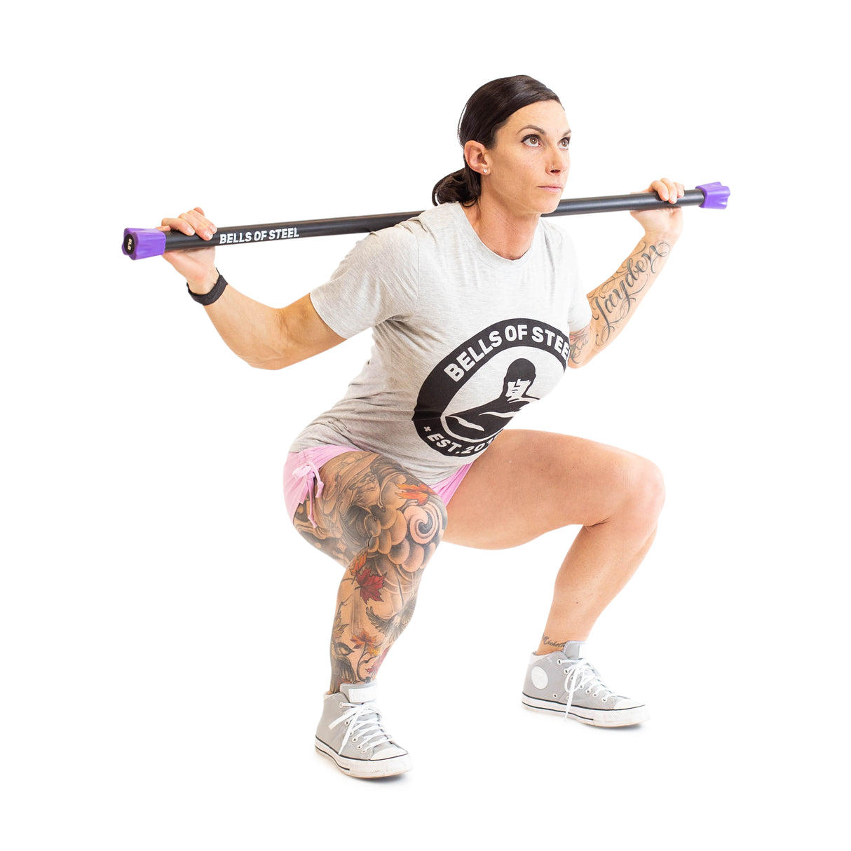 Female athlete doing back squats with Weighted Workout Body Bar