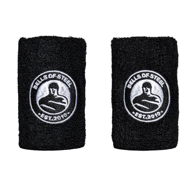 Two black wristbands from Bells of Steel USA feature a circular logo with a weightlifter silhouette and "BELLS OF STEEL" and "EST. 2010" text embroidered in white, embodying strength-building spirit with each move of the Wildman Clean & Press Adjustable Kettlebell Bundle.