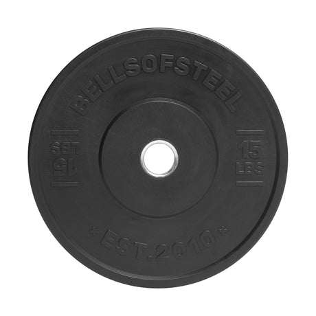 The Bells of Steel All-Black Bumper Plate weighs 15 lbs, is ideal for lifting equipment, and has "BELLSOFSTEEL" and "EST. 2010" engraved. It offers precise weight accuracy and a central hole for seamless barbell placement.