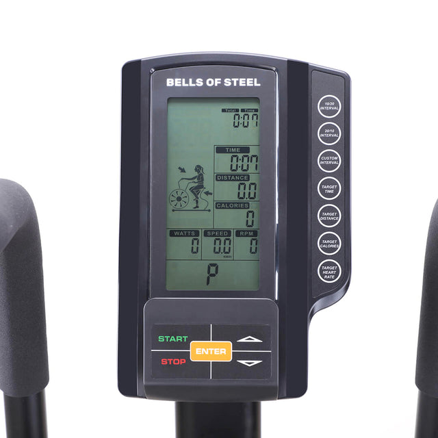 A close-up of the Bells of Steel Blitz Air Bike display reveals a digital screen showing time, distance, calories, speed, and RPM metrics. Equipped with start, stop, and enter buttons, it's ideal for fitness enthusiasts seeking a comprehensive home workout.