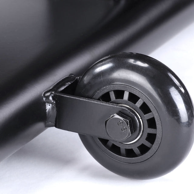 Close-up of a black caster wheel attached to a metal frame, reminiscent of those on the Bells of Steel Blitz Air Bike. Its smooth, shiny surface is firmly secured with a nut and bolt. The plain white background accentuates its details, ideal for your home gym setup.