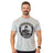 A smiling man with short hair and a mustache wears a light gray Bells of Steel Bamboo T-Shirt featuring a muscular figure logo and "Est. 2010" text, standing against a white background.