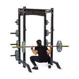 Product picture of Hydra Collegiate Power Rack PREBUILT with a male model performing squats