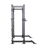 The Bells of Steel Manticore Collegiate Power Rack - Prebuilt (3" x 3", 1" Holes) is a black metal rack with adjustable attachments, ideal for weightlifting and strength training in any home gym, shown against a plain white background.