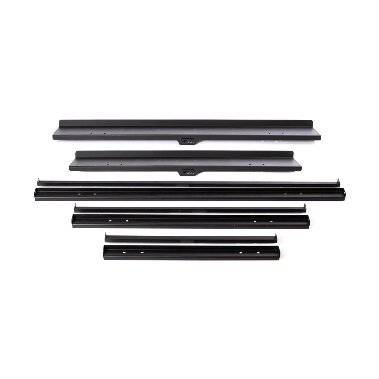 A set of black metal car parts on a white background, featuring long, narrow strips and sections with attachment holes, echoing the precision of the Bells of Steel Commercial Interchangeable Weight Rack.