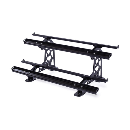 The Bells of Steel Commercial Interchangeable Weight Rack – Components Only features a simple, sturdy black metal structure with three horizontal bars akin to competition kettlebells, and boasts two side supports with cut-out patterns to secure the bars.