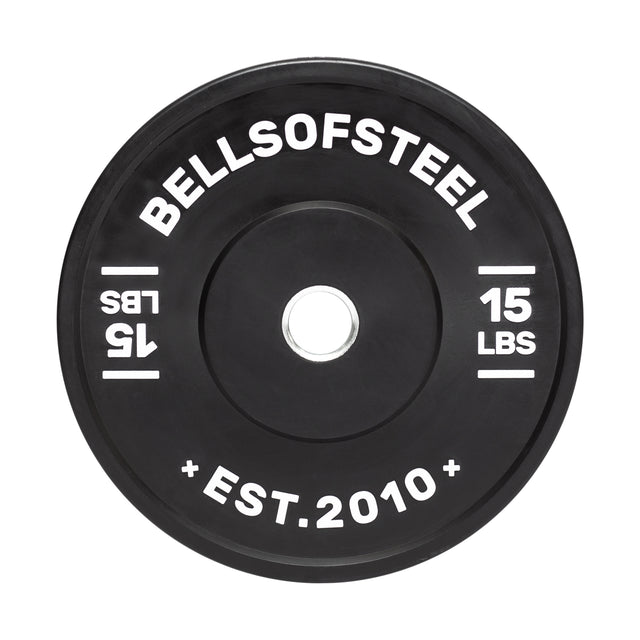 The Dead Bounce Conflict Bumper Plate by Bells of Steel is a 15 lb black weight with "Bells of Steel" and "Est. 2010" text. It's made of rubber with a stainless steel insert and has a central hole for barbell attachment.