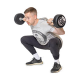 male model doing squat with fixed curl barbell