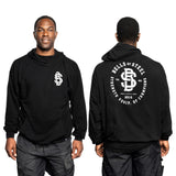 A man models a buttery soft "Bells of Steel" bamboo hoodie. The front features the logo and brand name, while the back showcases a large "Bells of Steel" design with "Strength Equip. of Champions" and "2010," emphasizing its sustainable bamboo material.