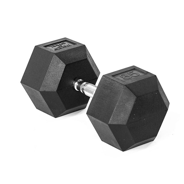 The Bells of Steel Ergo Rubber Hex Dumbbells, featuring a black hexagonal design with a metal handle, rest on a white background. The weight is clearly displayed on the side, epitomizing their commercial-grade durability.