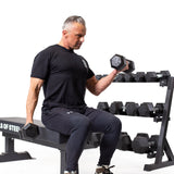 Male athlete doing seated biceps curl  using Ergo Rubber Hex Dumbbells