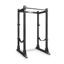 The Bells of Steel Manticore Flat Foot Power Rack - Prebuilt (3" x 3", 1" Holes) is a black metal power rack designed for weightlifting, featuring multiple 1-inch holes for adjustable safety bars and attachments. Ideal for both home gym and commercial use, this sturdy rack ensures superior stability and adaptability to meet all your fitness needs.
