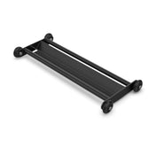 The Glute Ham Slider by Bells of Steel is a black, rectangular four-wheeled dolly designed for efficient transport of large, flat objects.