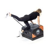 female athlete doing step ups with resistance straps and Soft Glute Bench