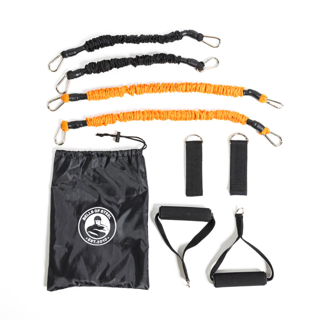 Two black and two orange resistance bands with carabiner clips, handles, ankle straps, and a Bells of Steel logo drawstring bag—great for home workouts or using with your Soft Glute Bench—shown on a white background.