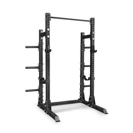 Introducing the Bells of Steel Manticore Half Rack Builder (3" x 3", 1" Holes)—a black metal power rack featuring sturdy 3x3 uprights, adjustable safety bars, integrated pull-up bar, and convenient weight plate holders. Expertly designed for strength training and weightlifting in your home gym.