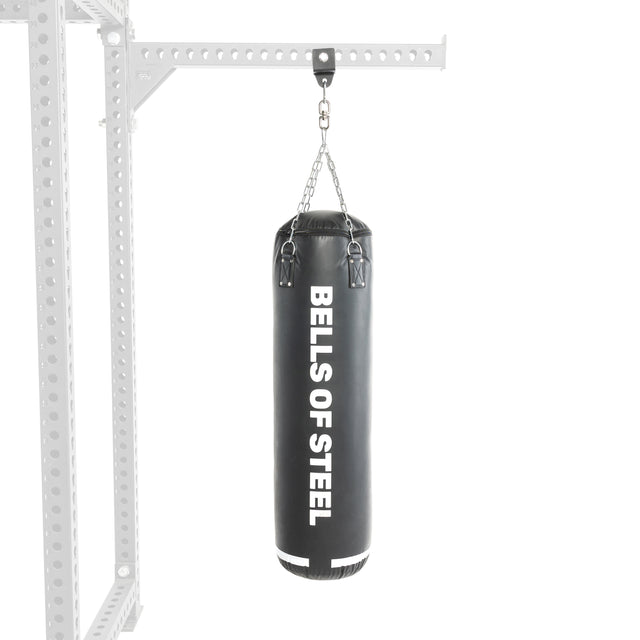 A "Bells of Steel" Heavy Bag Set in black hangs from a chain on a robust metal frame similar to a power rack, set against a white background.