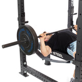Male athlete doing bench press with Hydra Four Post Power Rack PREBUILT focus
