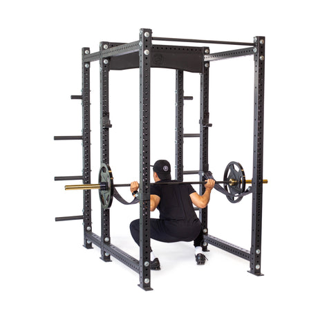 Product picture of Hydra Six Post Power Rack BUILDER with a male model performing squats