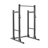 The Bells of Steel Hydra Half Rack - Prebuilt features a black sturdy metal frame with modular components, including adjustable supports and a pull-up bar. Designed for weightlifting and strength training, it has ⅝" holes for Hydra rack attachments to allow ultimate customization and stability.