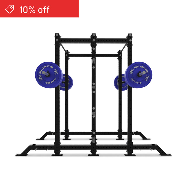 The Bells of Steel Hydra 2-Sided Rack power rack is shown with blue weight plates on both sides against a white background. Ideal for home gyms. A red banner at the top left announces "10% off.