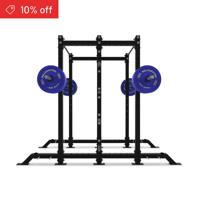 The Bells of Steel Hydra 2-Sided Rack power rack in black features blue weight plates on the barbell, ideal for any home gym. A red "10% off" banner appears in the top left, all set against a white background.