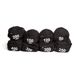 Seven black Bells of Steel Fitness Sandbag Sets, each labeled with weights from 50 to 400 lbs, are arranged in two rows against a white background, highlighting their durable construction—ideal for intense workouts.