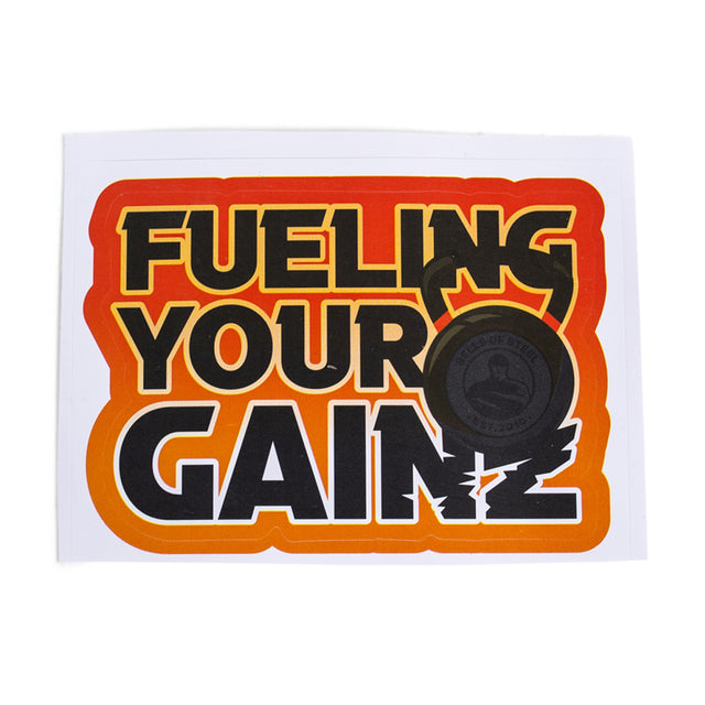 The Bells of Steel Stickers feature the bold text "FUELING YOUR GAINZ" in a yellow-orange-red gradient with a black kettlebell on a white background. They boast durable design and quality adhesive backing for lasting impact.