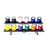 The Bells of Steel Commercial Interchangeable Weight Rack - Components Only features a two-tier design with a swappable shelf, holding twelve competition kettlebells in black, pink, blue, yellow, green, orange, and red in two neat rows.