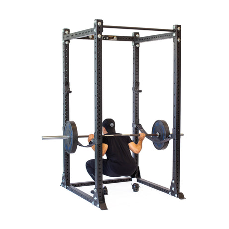 Product picture of Hydra Flat Foot Power Rack PREBUILT with a male model performing squats