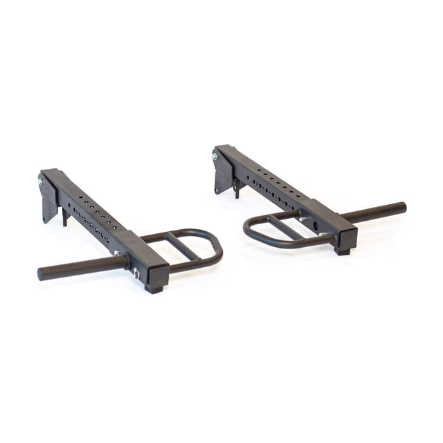 The Bells of Steel Lever Arms Rack Attachment includes two black adjustable arms that attach to a squat rack or power cage. They're designed as space-efficient safety spotters, featuring a sturdy base with multiple height adjustment holes and a horizontal bar for weight support.