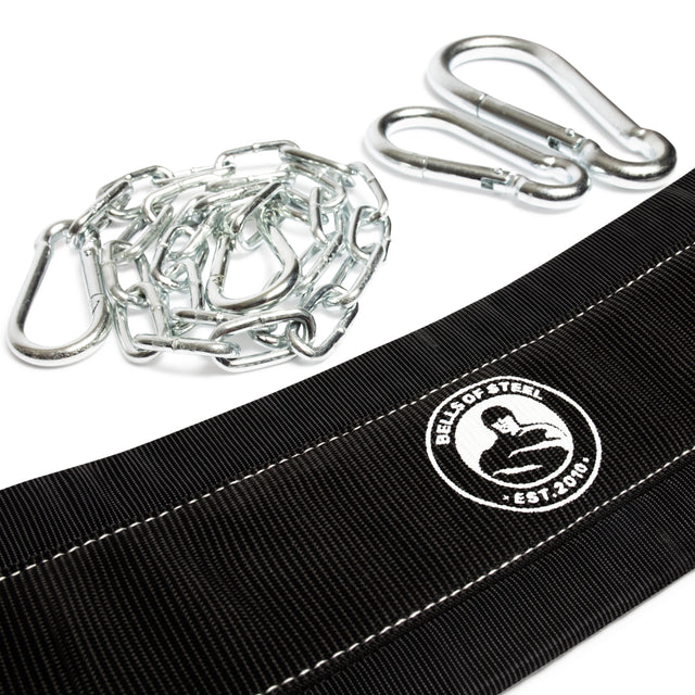 Close-up of a black Belt Squat Belt by Bells of Steel, featuring a flexing silhouette logo and white stitching. Perfect for enhancing belt squat routines, it comes with a metal chain and three carabiners, ready to pair with your power rack attachment for full-body workouts.