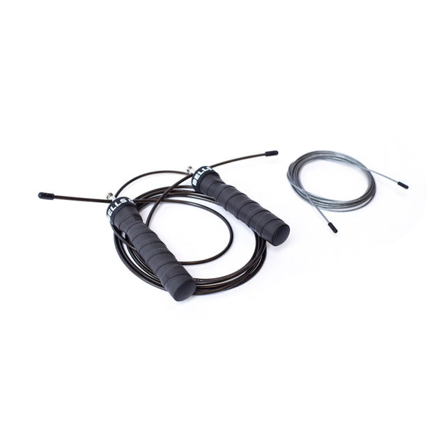 Two Bells of Steel jump ropes lie on a white background—one is black with ergonomic handles and a coiled cable, ideal for cardio training, and the other is gray with a neatly looped cable, lacking visible handles.