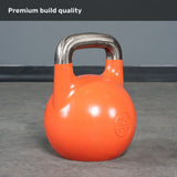 A Bells of Steel Competition Kettlebell with a bright orange finish and a polished metal handle rests on a gray floor, clearly marked “28KG 62LBS.” Bold white text at the top states “Premium build quality.” Like all Competition Kettlebells from Bells of Steel, it maintains an identical size across all weights to ensure consistent performance and grip.
