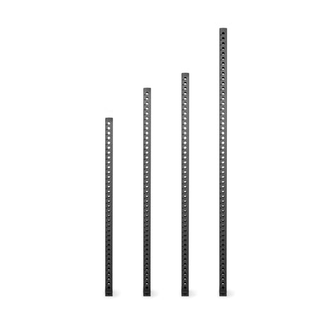 Four Manticore Vertical Uprights by Bells of Steel—black metal bars of varying heights with evenly spaced holes for rack attachments—stand in a row against a plain white background.