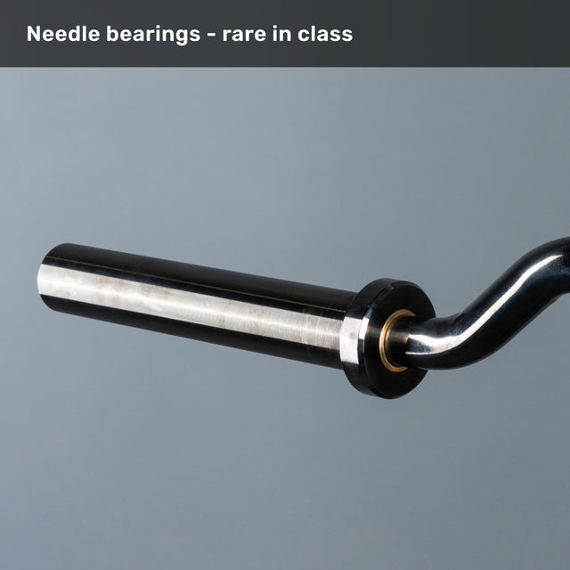A close-up of Bells of Steel’s Safety Squat Bar - The SS4 shaft and sleeve on a grey background, with text: "Needle bearings – rare in class. Perfect for intense leg day or barbell squats.