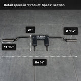 The Bells of Steel Safety Squat Bar - The SS4, in black with a padded center, lies on a gray tile floor. Measurements: total length 86 5/8", center to handle 21", handle diameter 1 1/4", end to pad 11 13/16"—ideal for squats.