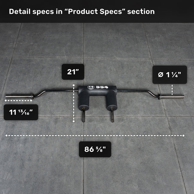 The Bells of Steel Safety Squat Bar - The SS4, in black with a padded center, lies on a gray tile floor. Measurements: total length 86 5/8", center to handle 21", handle diameter 1 1/4", end to pad 11 13/16"—ideal for squats.