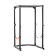 The Bells of Steel Light Commercial Power Rack (2.3" x 2.3", ⅝" holes) features black metal construction, multiple adjustment holes, sturdy uprights, and two orange safety straps for barbell protection—ideal for weightlifting and home use.