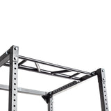 A close-up of a metal pull-up bar attachment with angled grips mounted on the Bells of Steel Light Commercial Power Rack (2.3" x 2.3", ⅝" holes), designed for home training, shown against a white background.