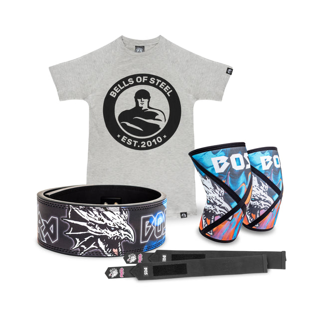 The Lever Belt Package by Bells of Steel USA includes a gray T-shirt with the "Bells of Steel Est. 2010" logo, a lever belt with a dragon design, colorful knee sleeves, black lifting straps accented in blue and red, and durable wrist wraps for optimal support.