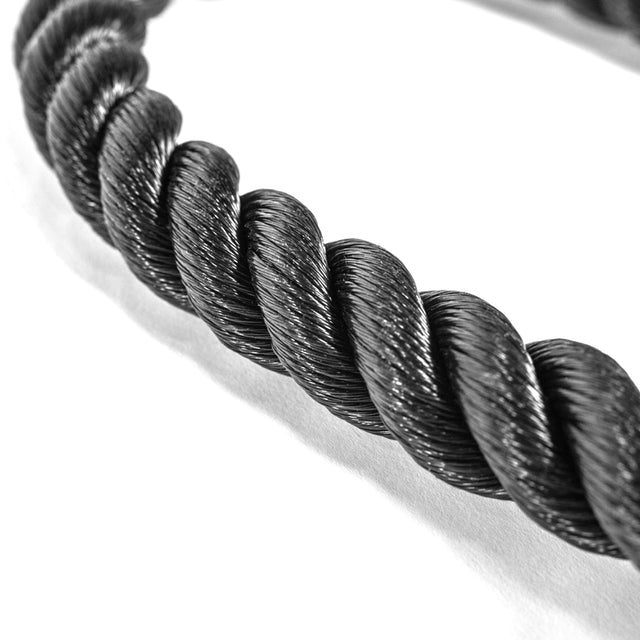 Close-up of a Bells of Steel Tricep Rope Extension, intricately twisted against a white background. The black rope's woven texture is highlighted, ideal for cable machine use.