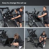 Two people from Bells of Steel demonstrate how to adjust the Leg Press Hack Squat Machine in four easy steps, showing the simple setup process against a plain gray wall and floor.