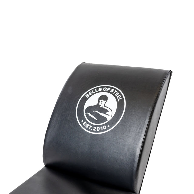 Close-up of the Luxury Sit Up Mat's black padded backrest, ideal for core workouts, featuring the white "Bells of Steel" logo with a muscular figure and "EST. 2010." The design is centered for comfortable lumbar support during exercises.